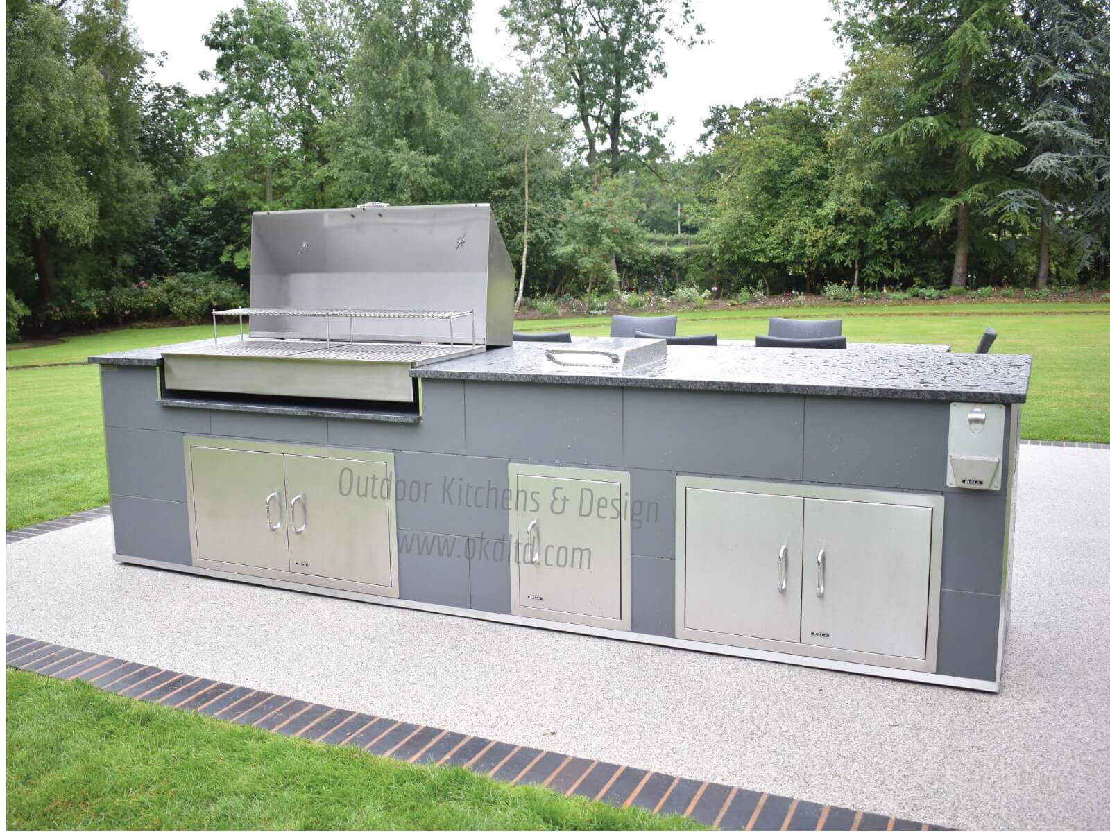 Contemporary outdoor kitchen with custom made charcoal BBQ